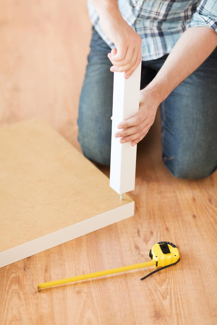 Straight leg being installed on a side table with hanger bolts