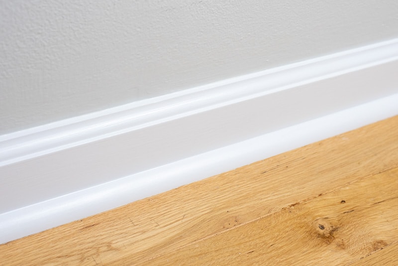 freshly painted baseboards with oak floors