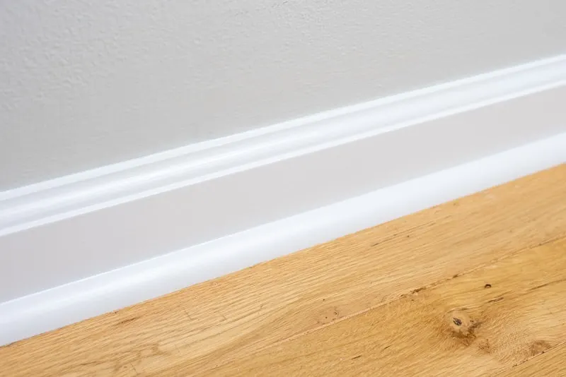 freshly painted baseboards with oak floors