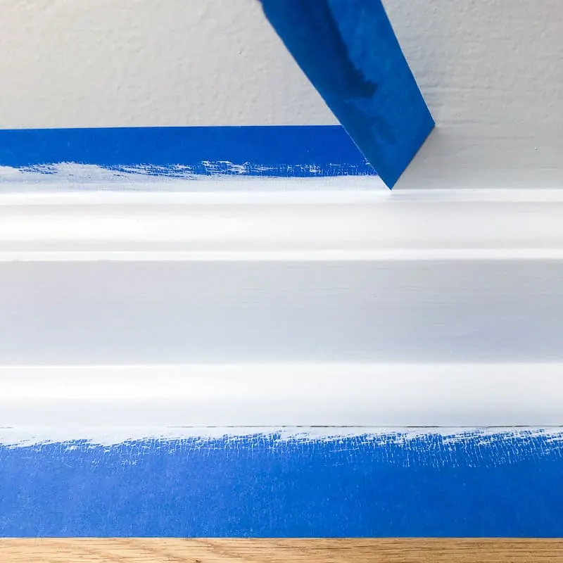 pulling off painter's tape from baseboards