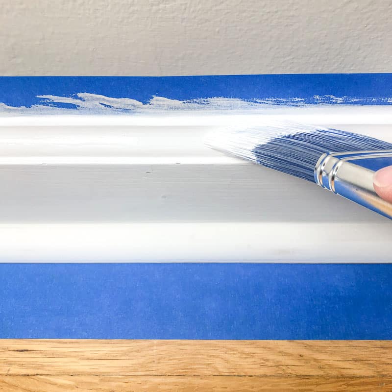 painting the decorative edge of the baseboards