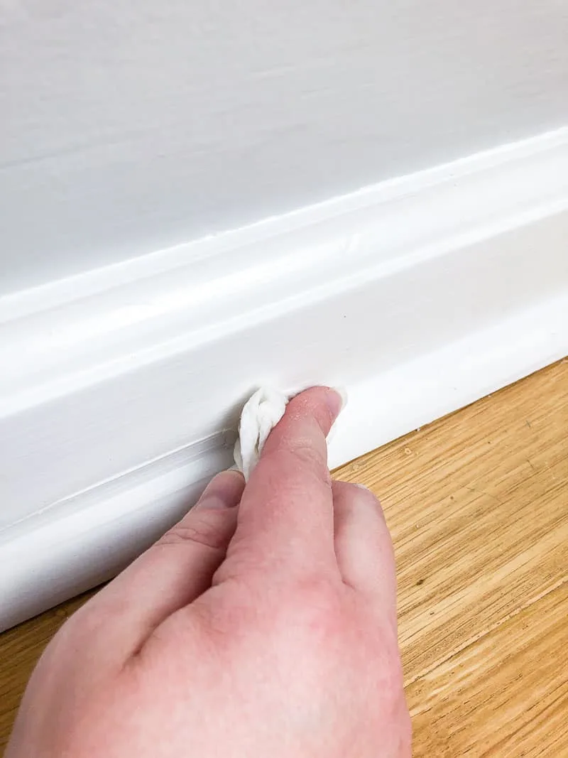 smoothing caulk line with finger