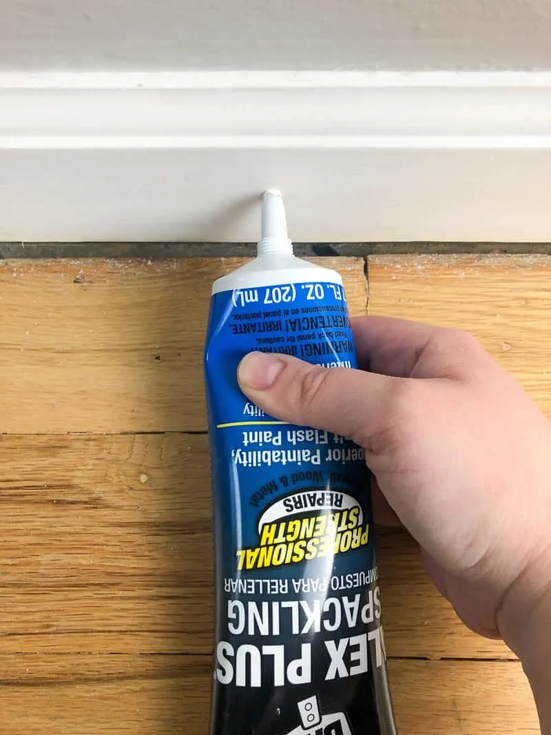 filling nail holes in baseboards with spackle