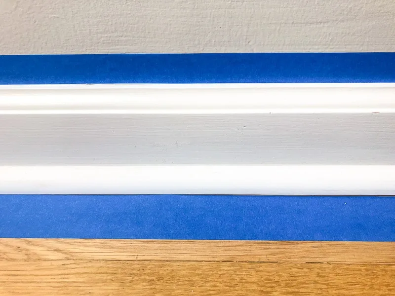 painter's tape above and below baseboards