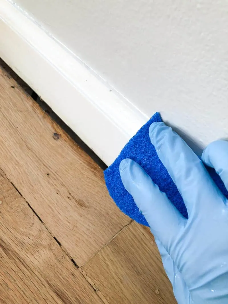 wiping down baseboards before painting