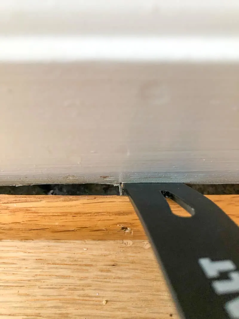 using the flat end of a small pry bar to remove quarter round trim
