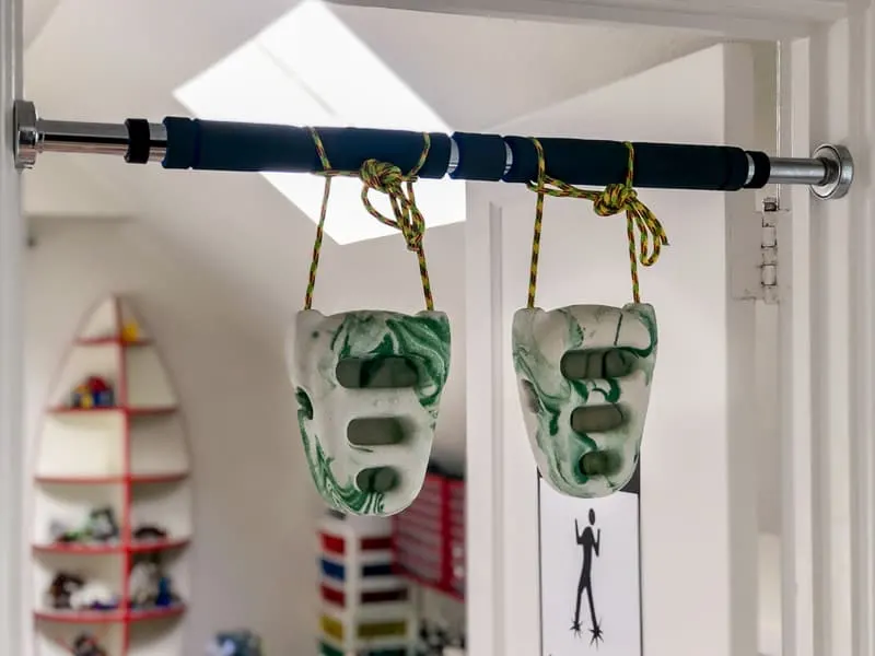 Rock rings tied to a pull up bar across a doorway