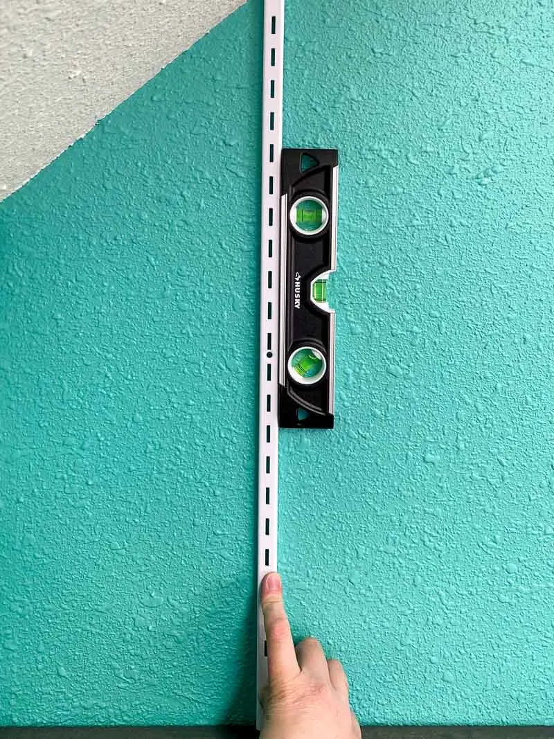 magnetic level attached to metal adjustable shelf standard