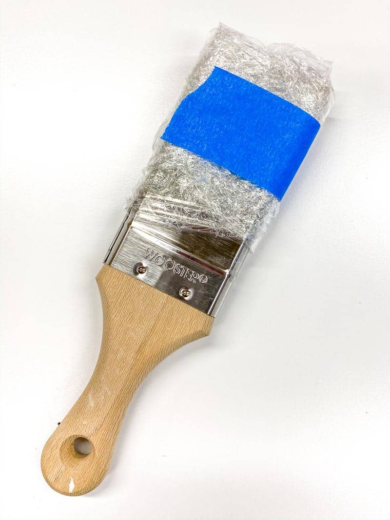 wet paint brush wrapped in plastic wrap
