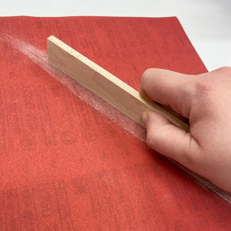 sanding edges of ¼" maple with a full sheet of plywood on a workbench