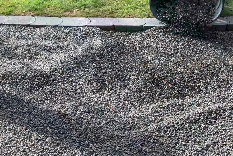 dumping pea gravel into patio area