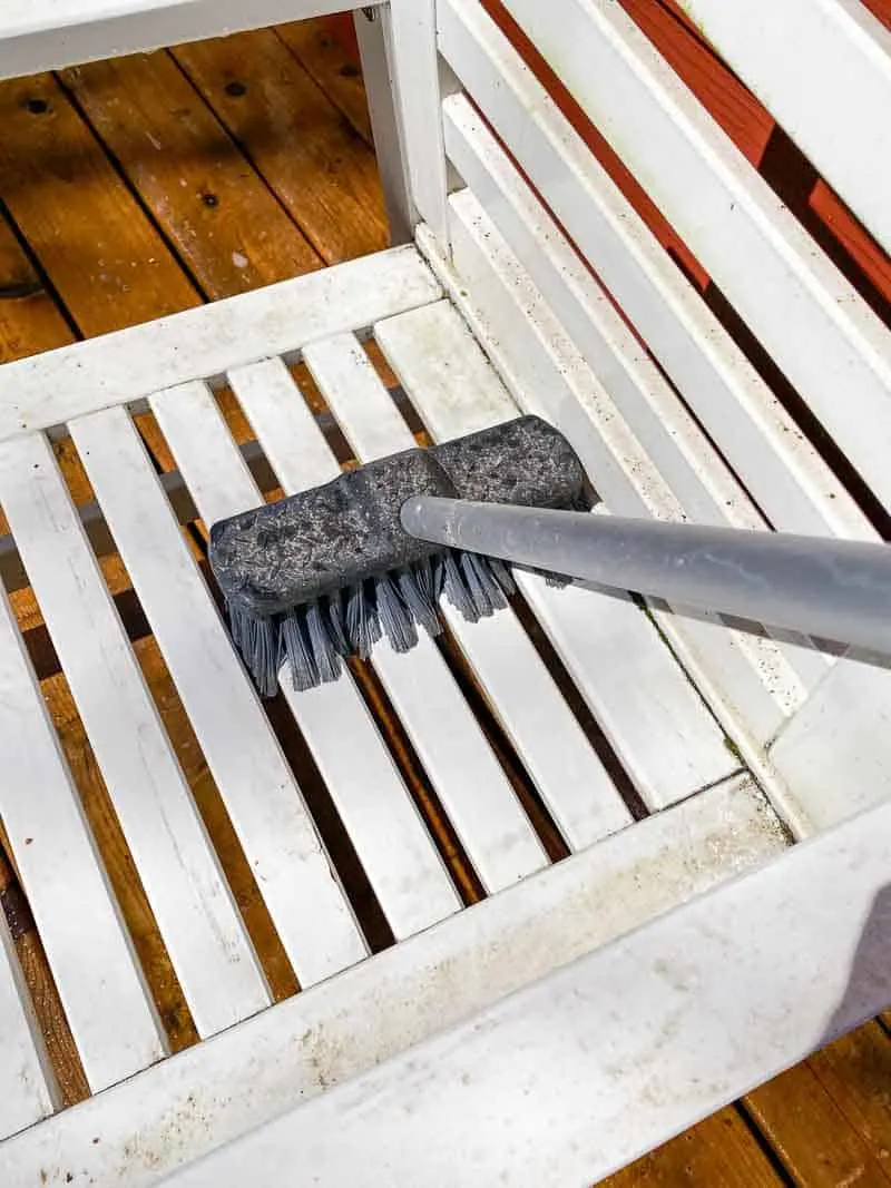 scrubbing outdoor furniture with cleaner