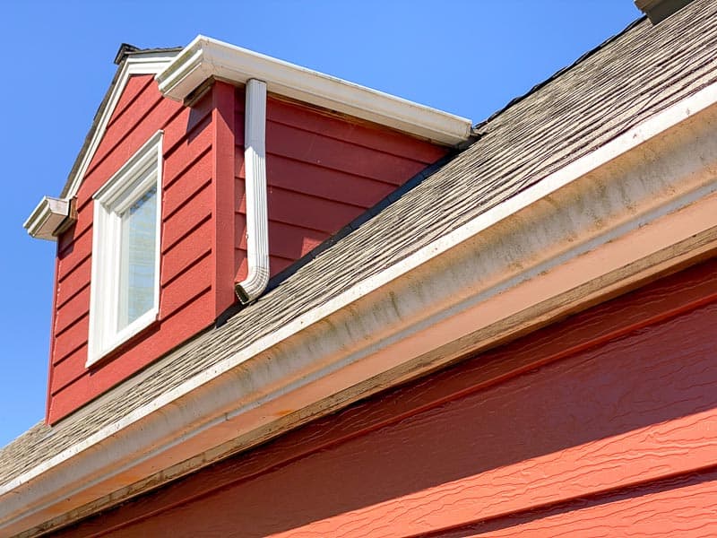 dirty white gutters on back of a house