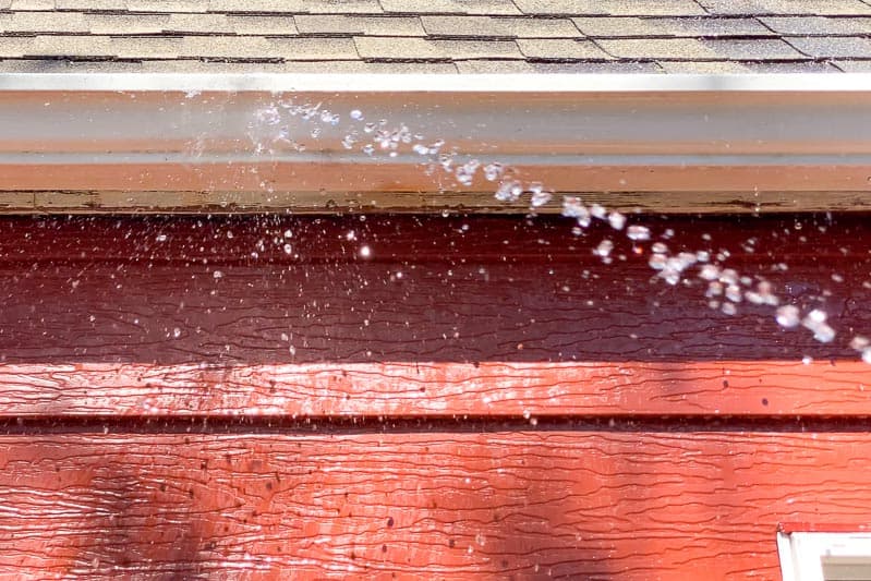 rinsing outside of gutters after cleaning