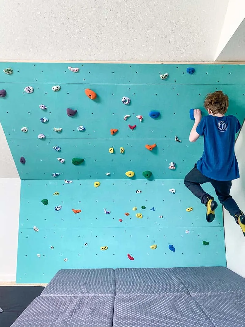 kid doing pull up on home climbing wall