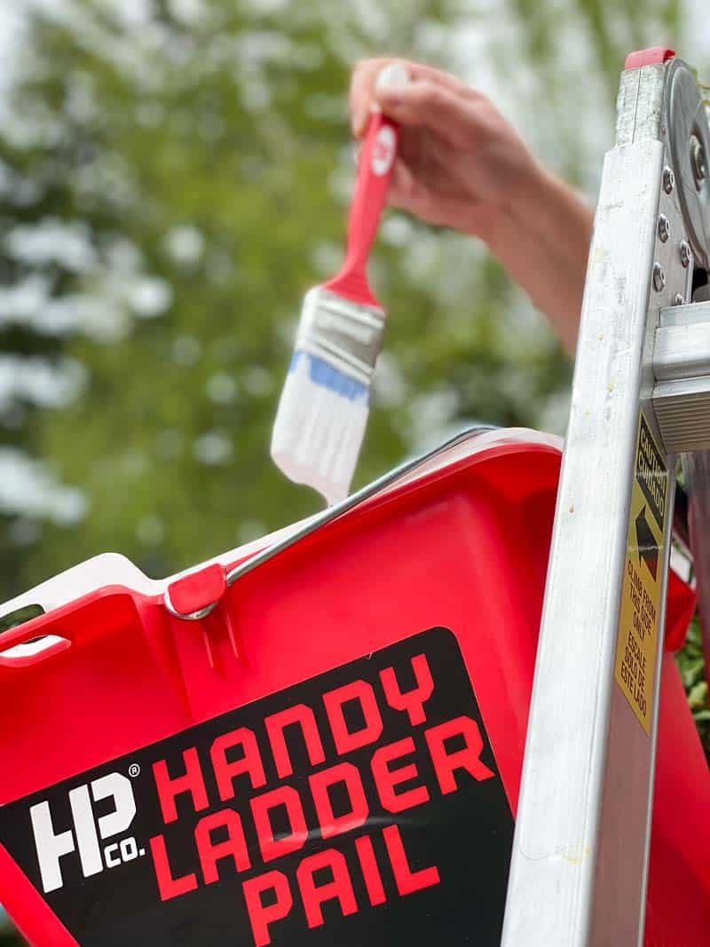 Handy Ladder Pail on ladder with paint brush coming out of paint