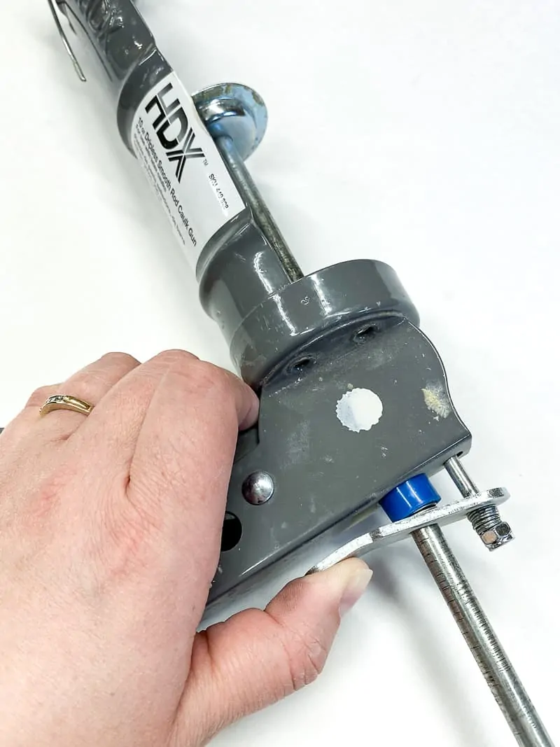 how to release the pressure on a caulk gun to remove the tube
