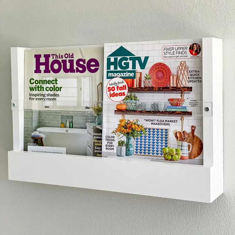 DIY magazine rack on wall with HGTV and This Old House magazines