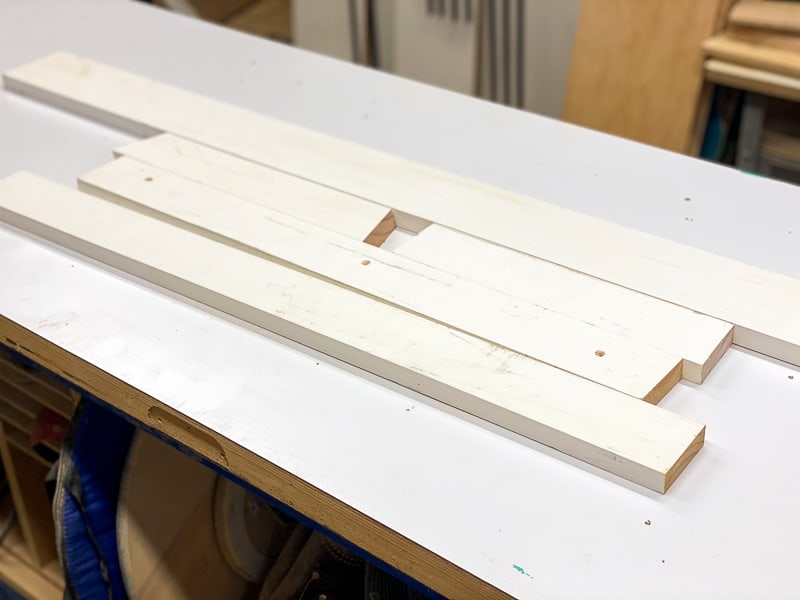 scrap wood for DIY magazine rack on workbench
