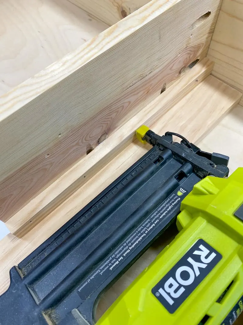 attaching bin supports to sides of Trofast shelf with Ryobi brad nailer