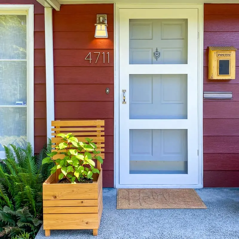 front porch with DIY screen door and planter box