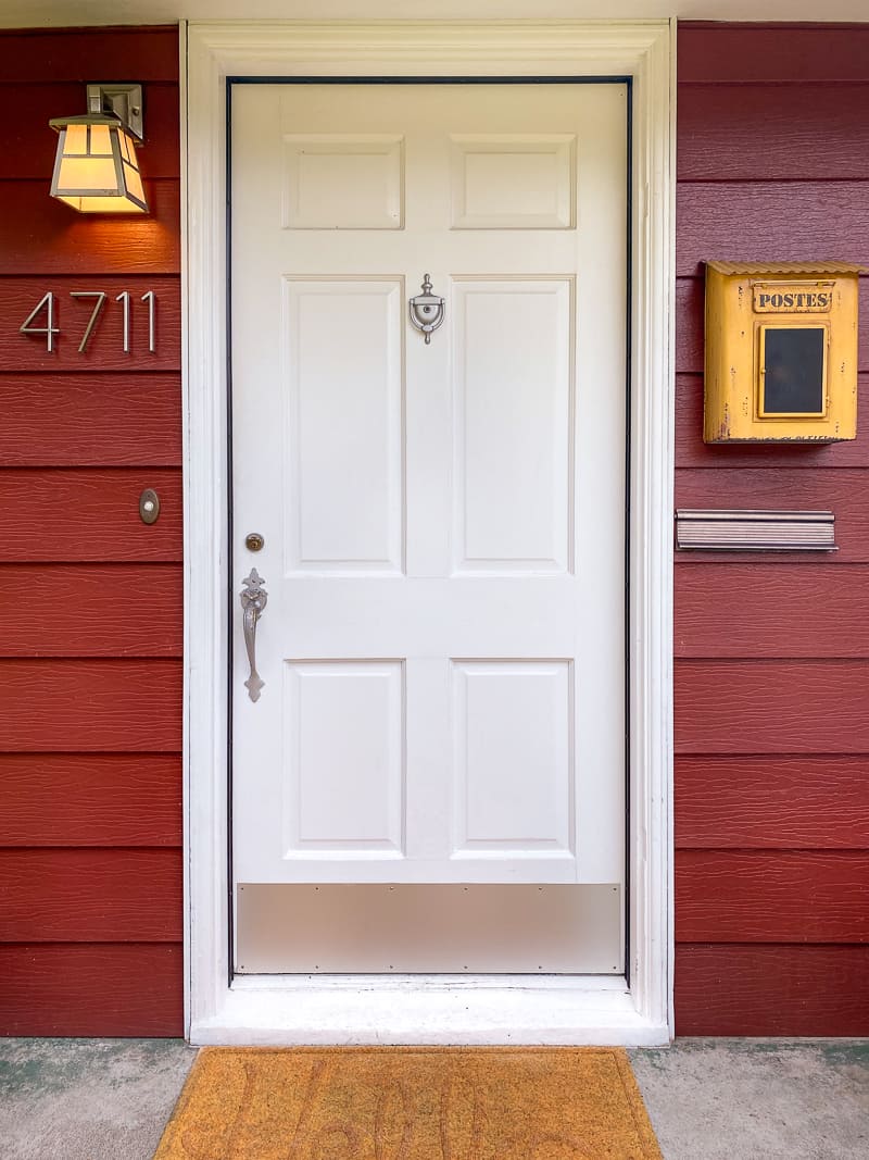 front door with mailbox and light fixture