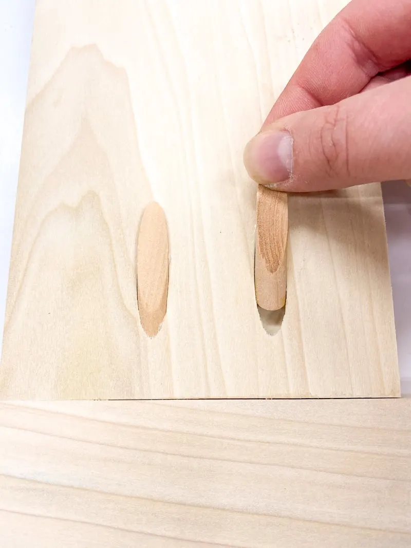 inserting wood pocket hole plug into hole