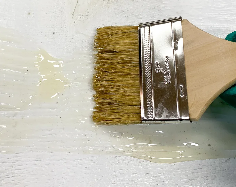 chip brush smoothing out paint stripper