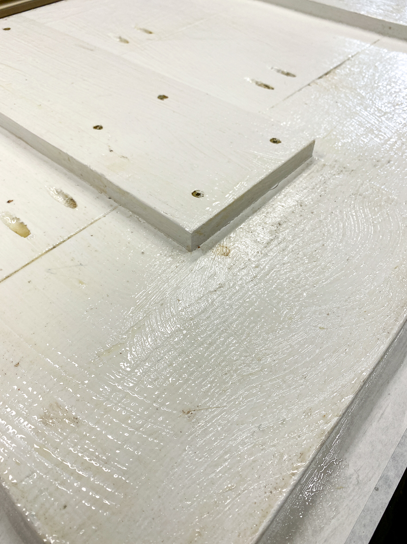 even coat of paint stripper applied to white painted boards