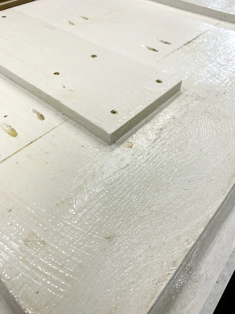 even coat of paint stripper applied to white painted boards