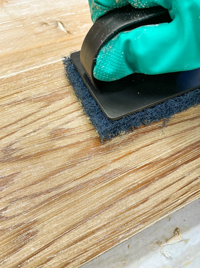 using a scrub brush to remove the last bits of paint from wood