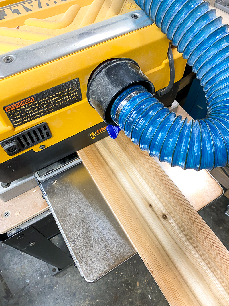 cedar board coming out of a planer