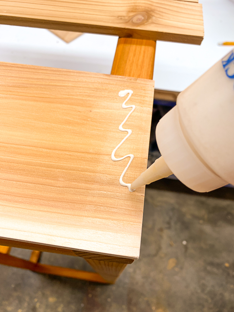 applying wood glue to cedar slats