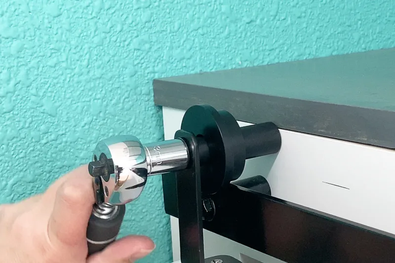 attaching stationary wheel of bifold barn doors to cabinet