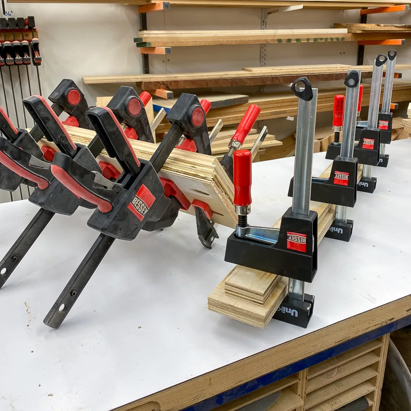 clamped stacks of glued plywood scraps for wooden climbing holds