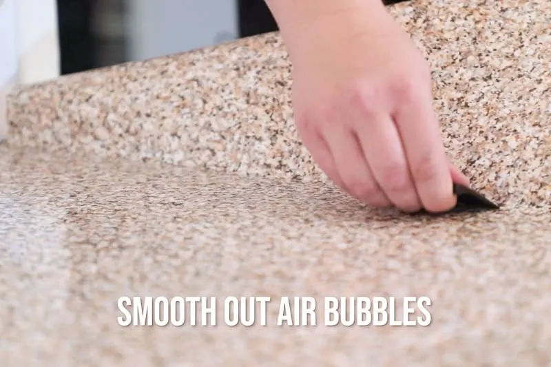 smoothing out air bubbles from countertop contact paper