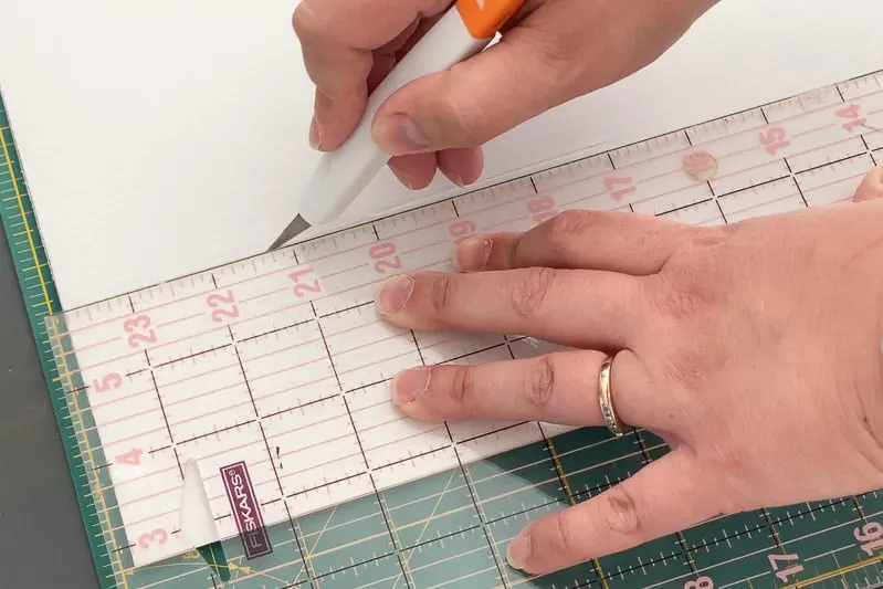 cutting out dividers from plastic corrugated board with a utility knife and ruler