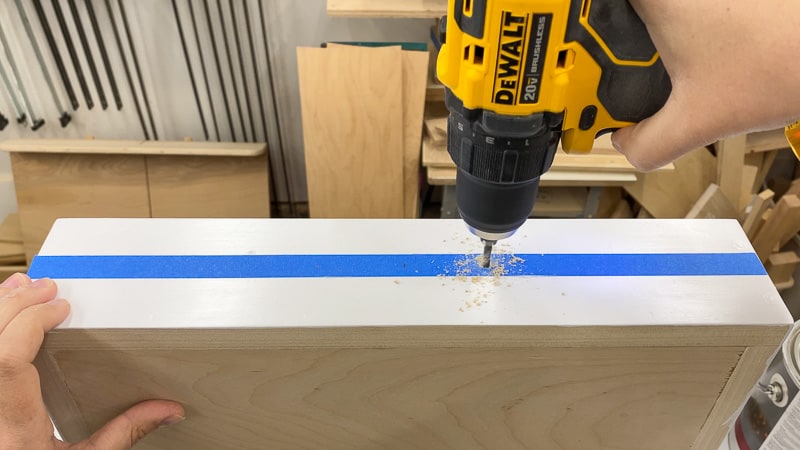 drilling holes for handles on sides of Lego tray using painter's tape guide