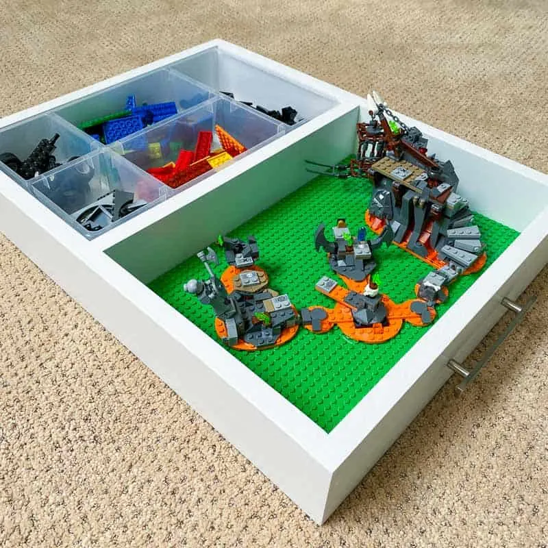 DIY Lego tray with pieces sorted in organizer and Lego project on baseplates
