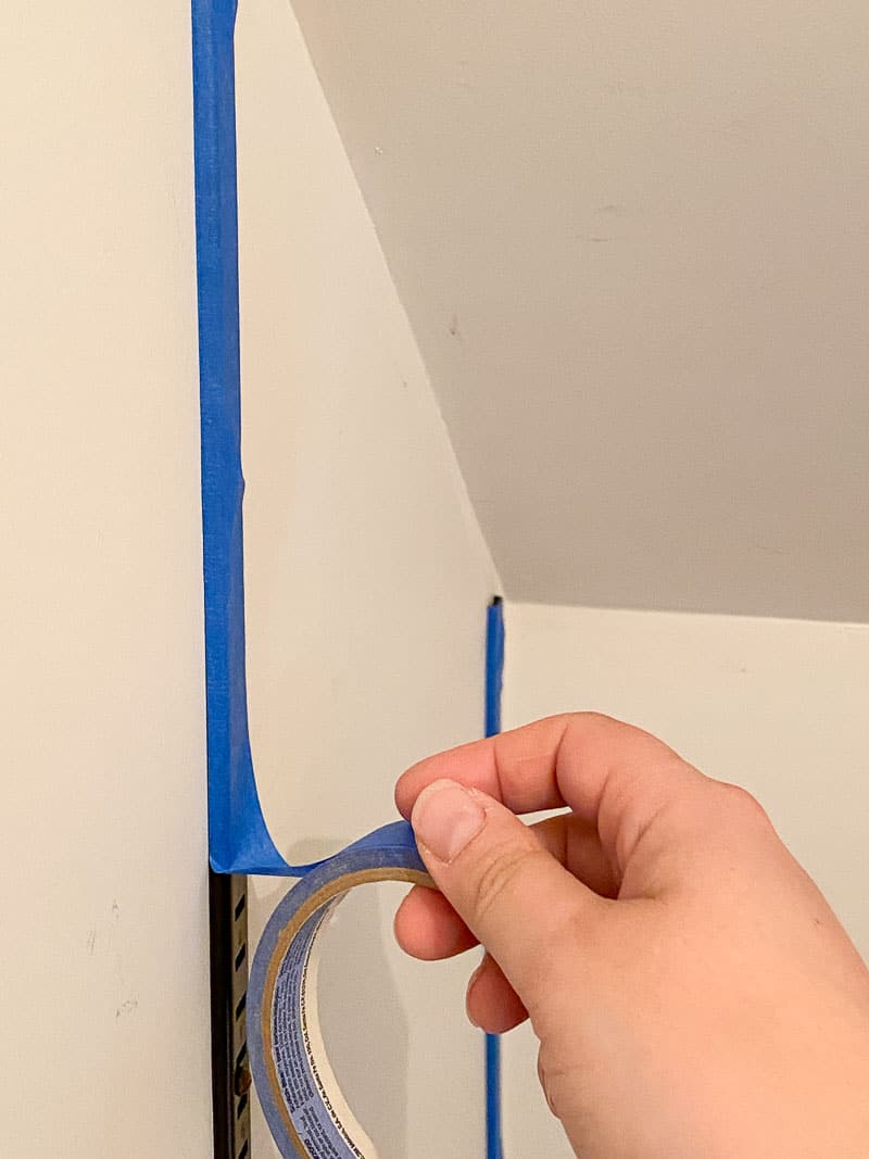 covering vertical brackets of shelving system with painter's tape