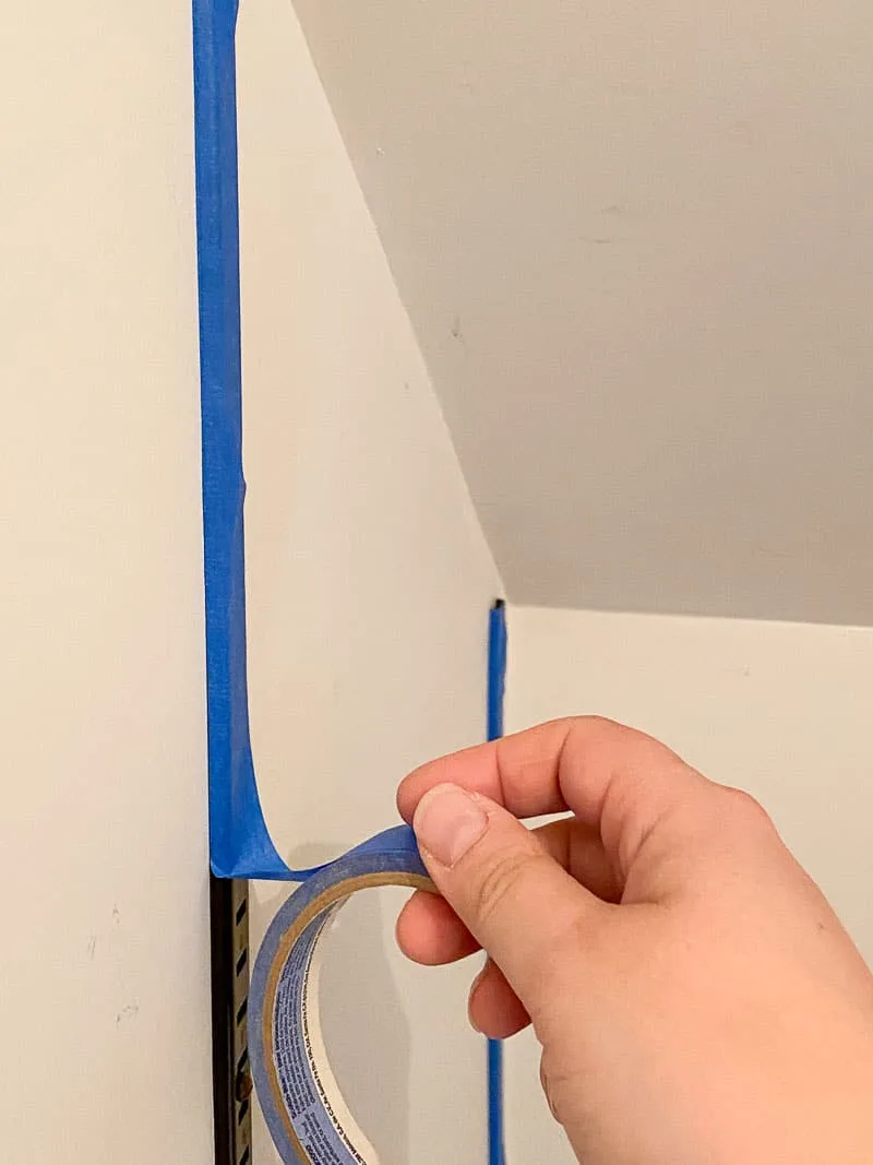 covering vertical brackets of shelving system with painter's tape