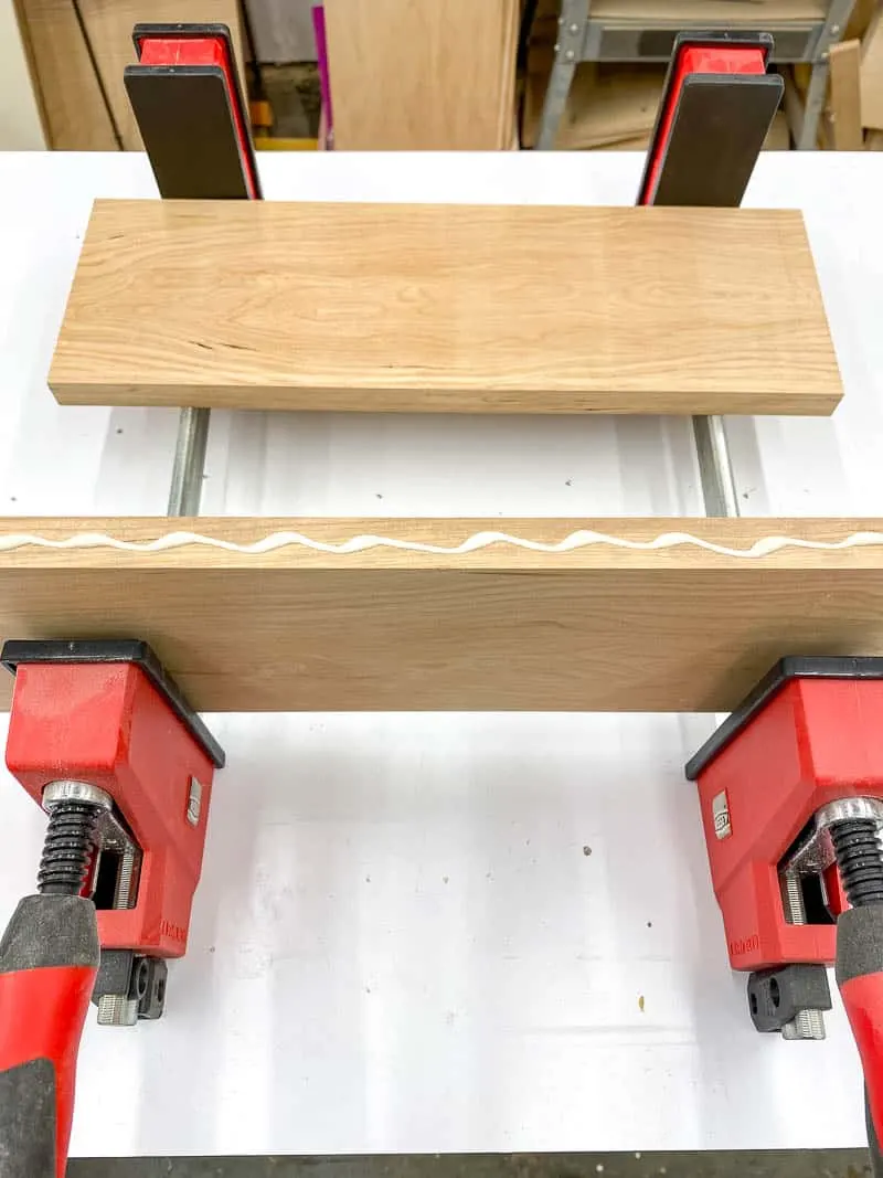 wood glue applied to the edge of one board before clamping