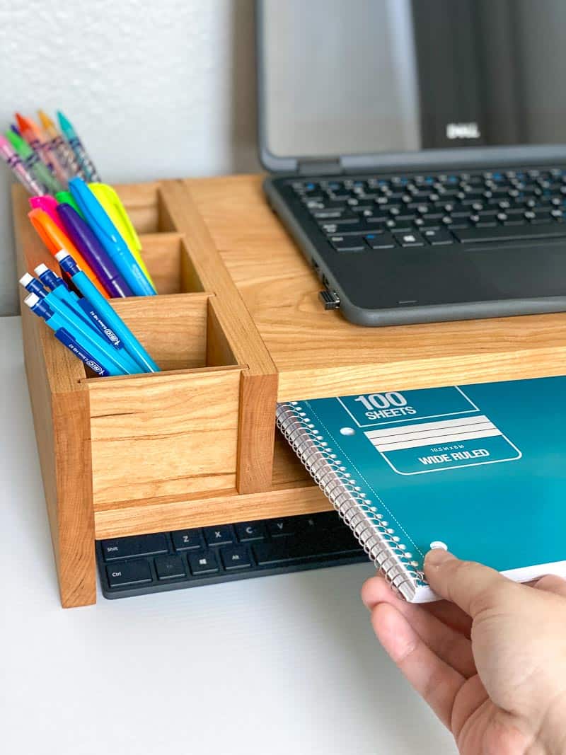 DIY laptop stand with notebook being removed