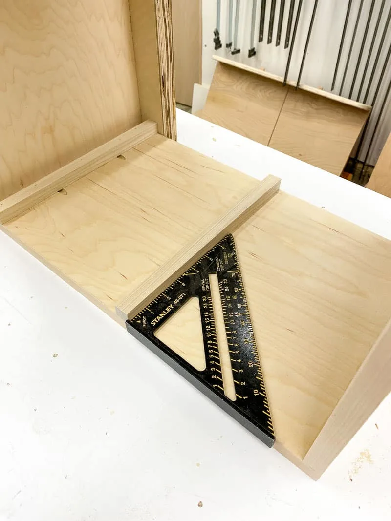 using a square to keep the bottom slide of the storage bin frame straight