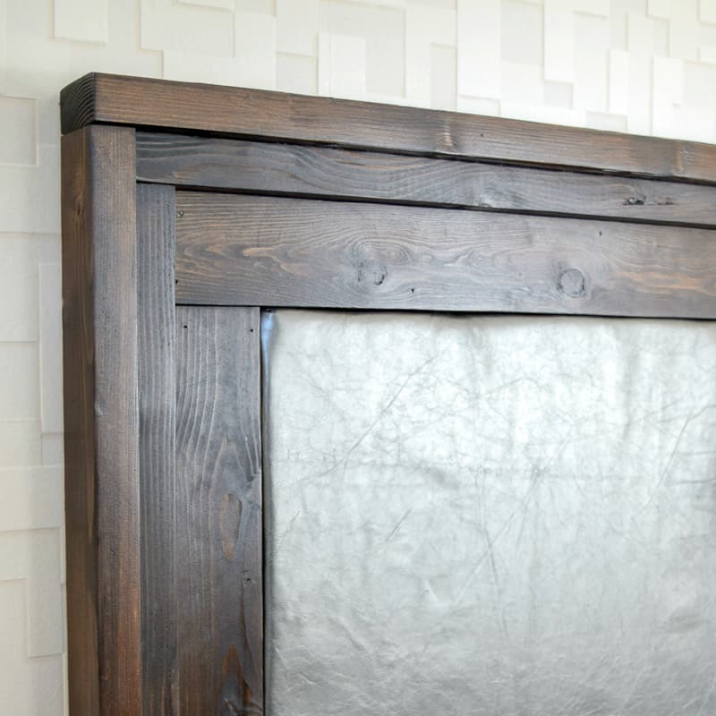 DIY upholstered headboard with dark wood trim