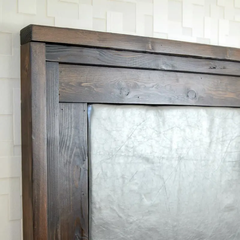 DIY upholstered headboard with dark wood trim