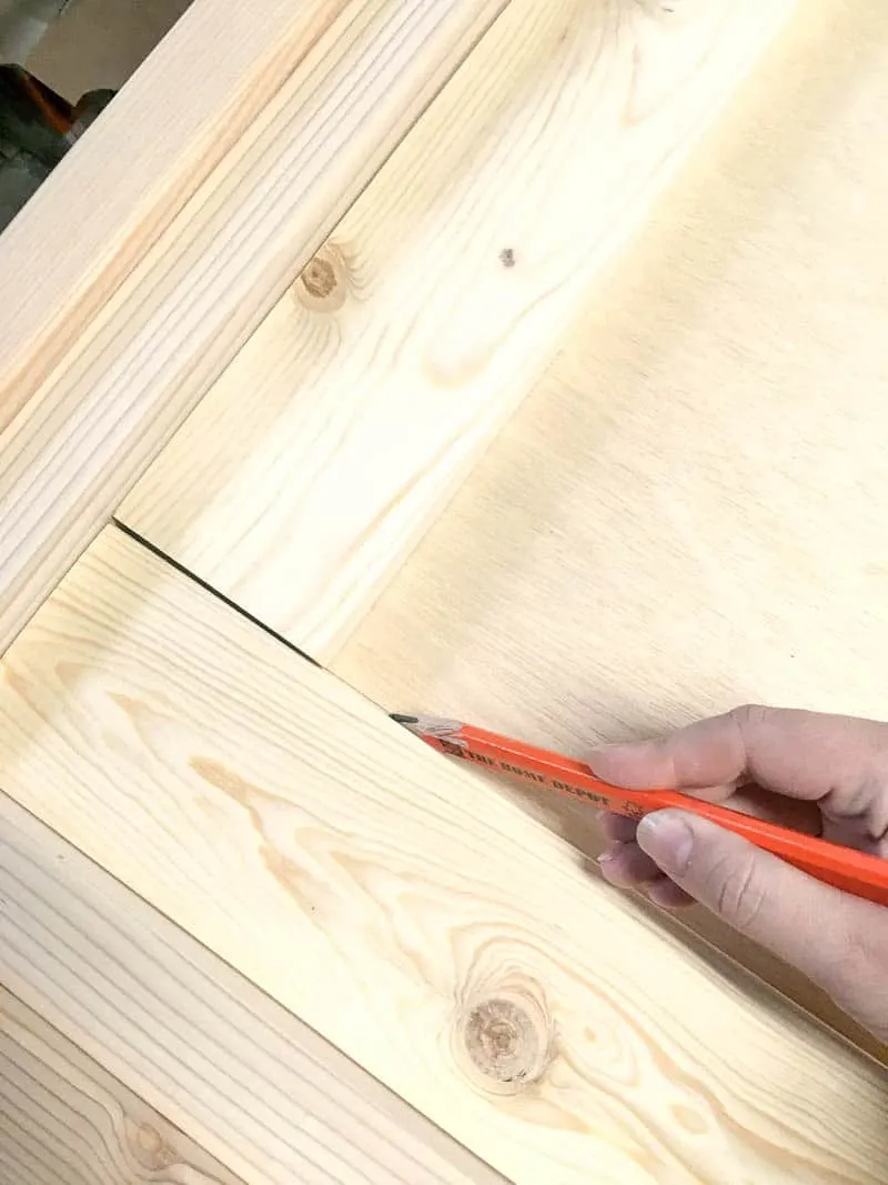 Marking position of 1x4 frame on plywood back of headboard