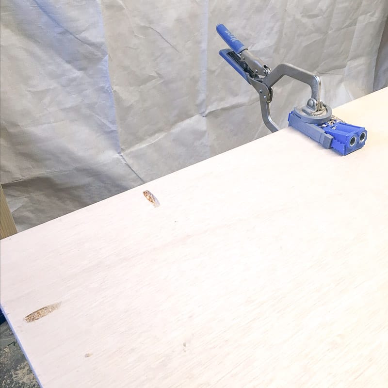 drilling pocket holes along outside edge of plywood backing