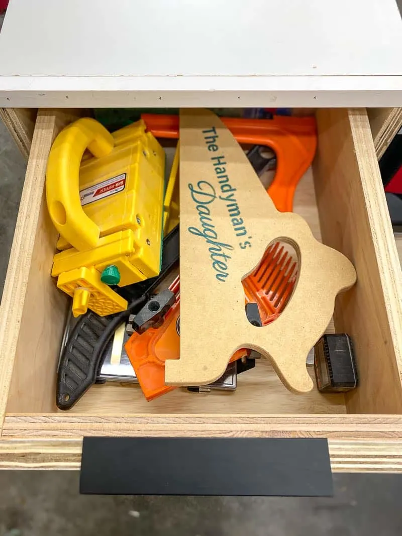 drawer open with table saw push sticks and blocks inside