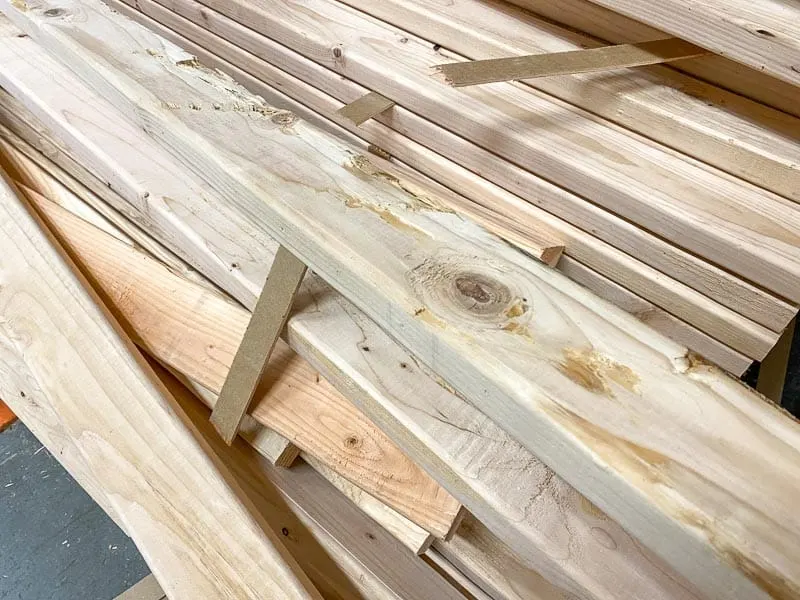 stack of 2x4s with damaged boards on top